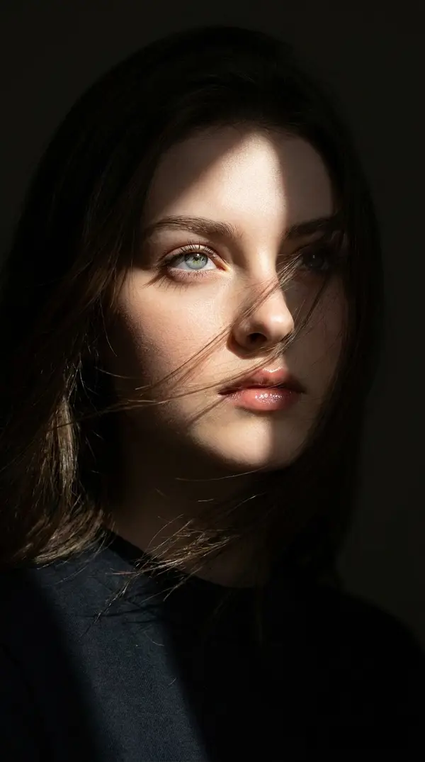 Woman with Windswept Hair Dramatic Lighting