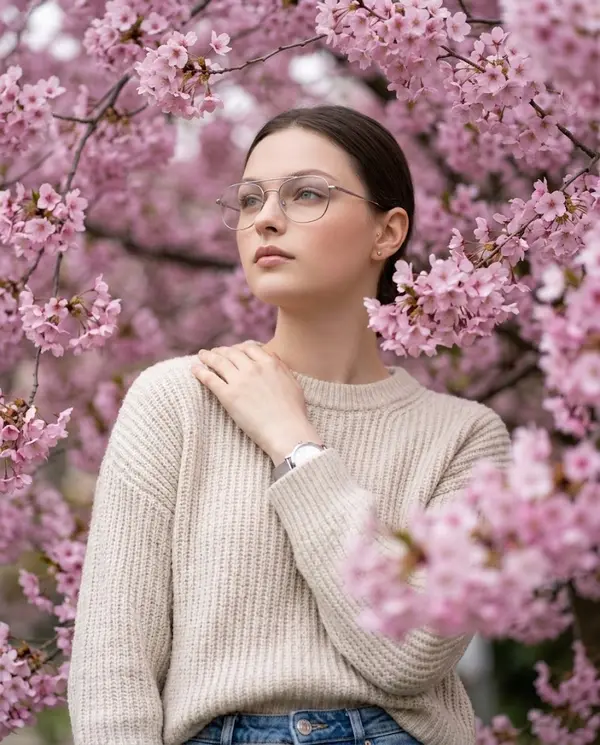 Woman among cherry blossoms serene portrait