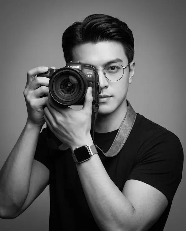Young Man with Camera Studio Portrait Black and White